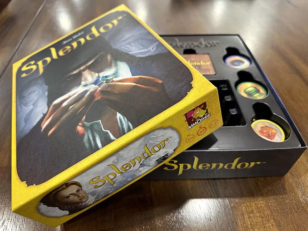 The Splendor board game opened to reveal its contents.