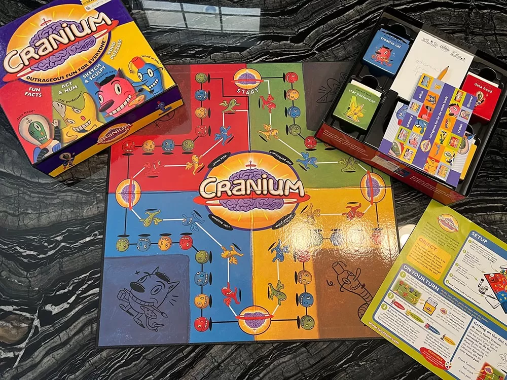 The Cranium board game box open on a table.