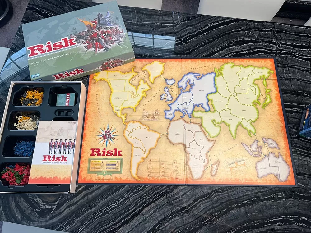 The risk board game open to show the game board and game components.