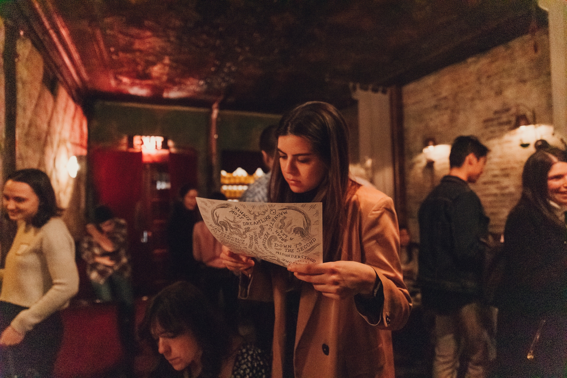 A woman solves a clue in a speakeasy.